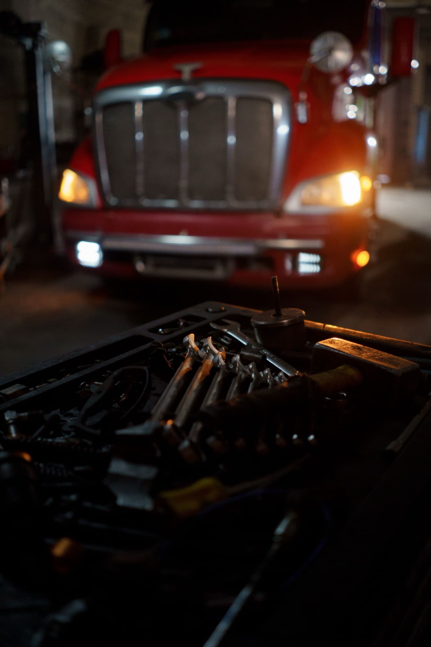 Organized hand tools in front of an unbranded work truck.